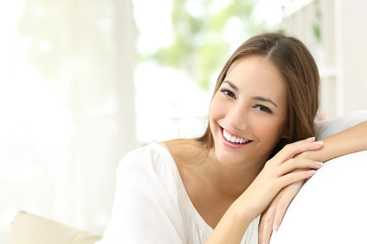 A woman smiling confidently after clear aligner treatment